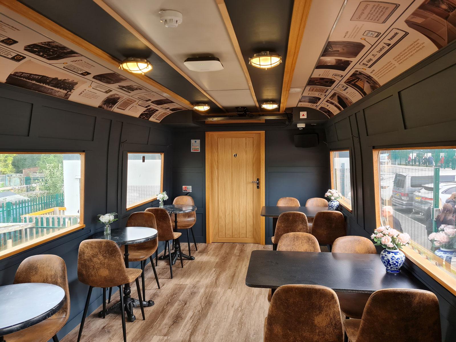 Interior of a railway carriage refurbished as a school cafe.