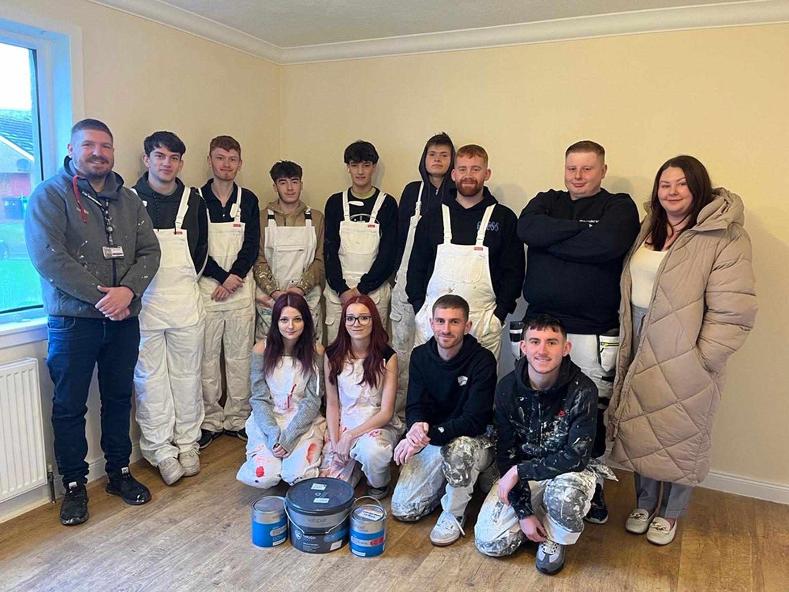 Students from UHI Inverness help to paint a flat for a charity.